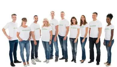 Group of nine diverse people standing in a row, wearing matching white t-shirts with the word "gogreen" printed on them.