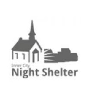 Logo of inner city night shelter featuring a stylized church and adjacent buildings in gray scale.